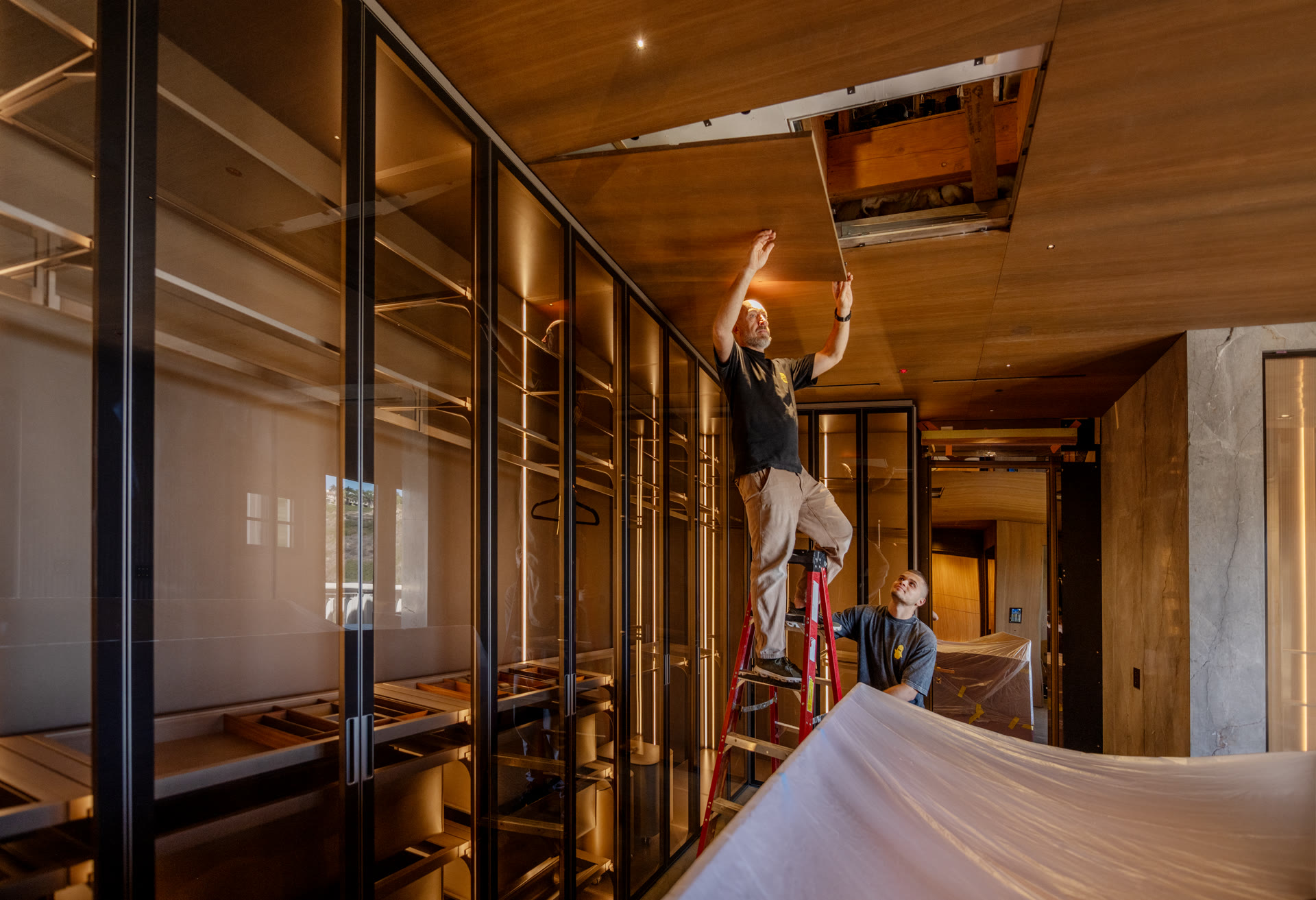 Crew installing ceiling panels in high-end interior